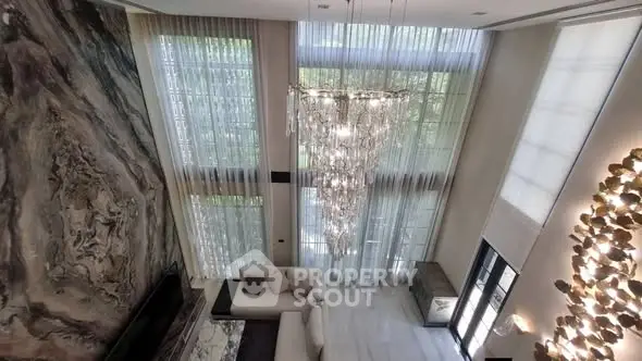 Luxurious living room with high ceilings and elegant chandelier