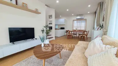 Modern open-plan living room with cozy decor and dining area