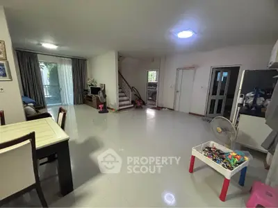 Spacious living room with modern decor and large windows for natural light.