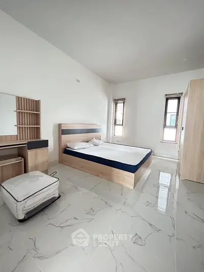 Spacious modern bedroom with sleek furniture and natural light