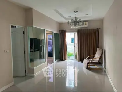 Spacious living room with modern chandelier and garden view