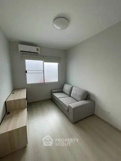 Minimalist small living room with sofa and natural light
