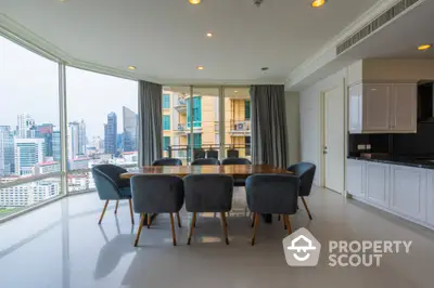 Spacious dining area with panoramic city view and modern furnishings in luxury apartment.