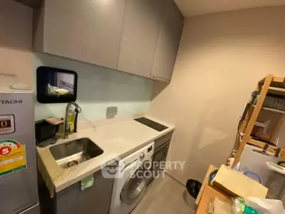 Modern compact kitchen with washing machine and sleek cabinetry