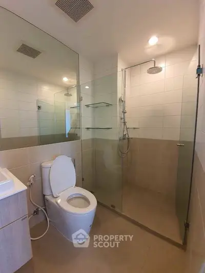 Modern bathroom with glass shower enclosure and sleek fixtures