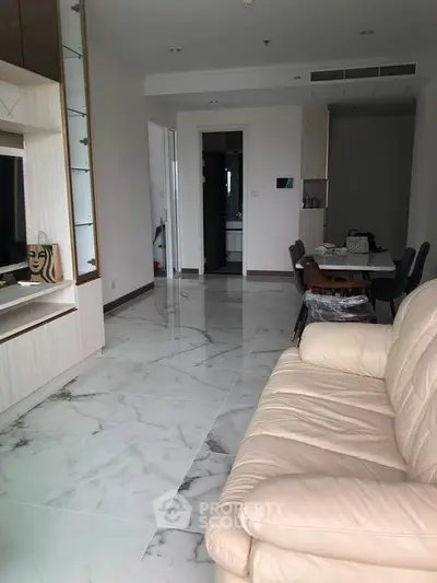 Spacious modern living room with marble flooring and cozy leather sofa
