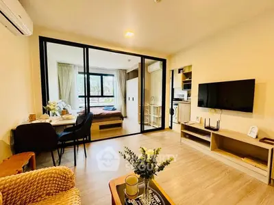 Modern open-plan living room with stylish decor and natural light