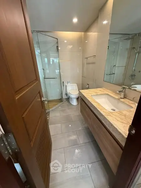 Modern bathroom with glass shower and elegant sink vanity