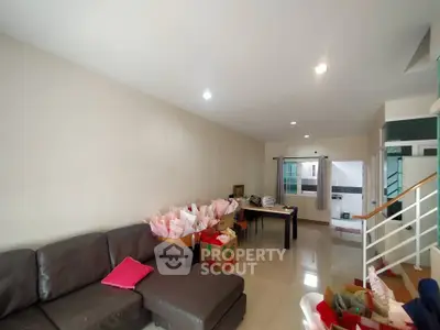 Spacious living room with modern furniture and ample natural light, perfect for family gatherings.