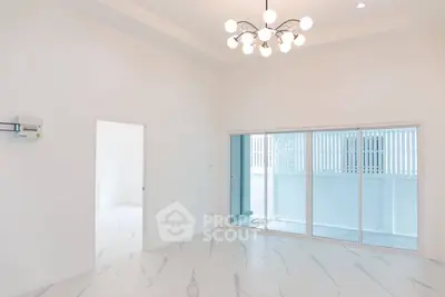 Spacious modern living room with elegant lighting and large sliding glass doors.