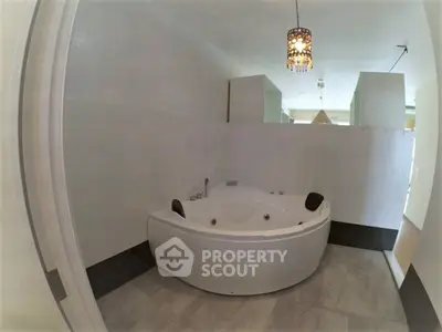 Luxurious bathroom with modern jacuzzi tub and elegant lighting