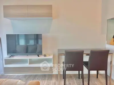 Modern living room with sleek TV setup and stylish dining area, perfect for urban living.