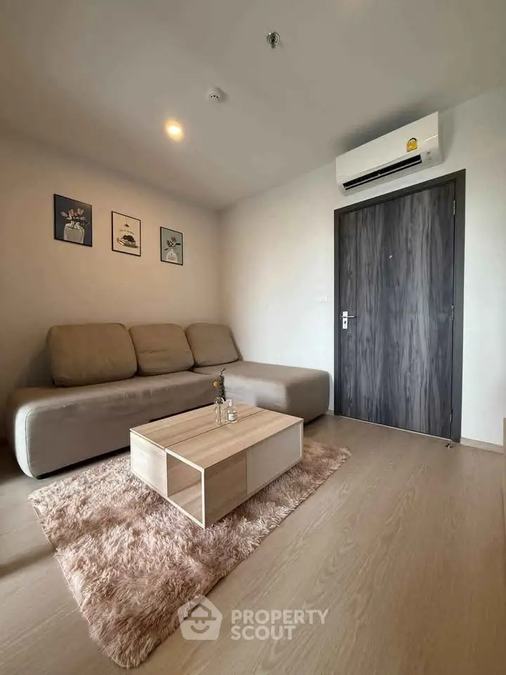Modern living room with cozy sofa and stylish decor in a contemporary apartment.