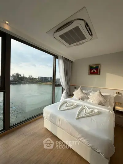 Luxurious bedroom with stunning water view and elegant decor