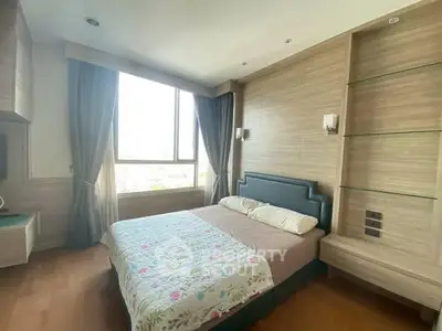 Spacious bedroom with large window and modern decor, perfect for relaxation and comfort.