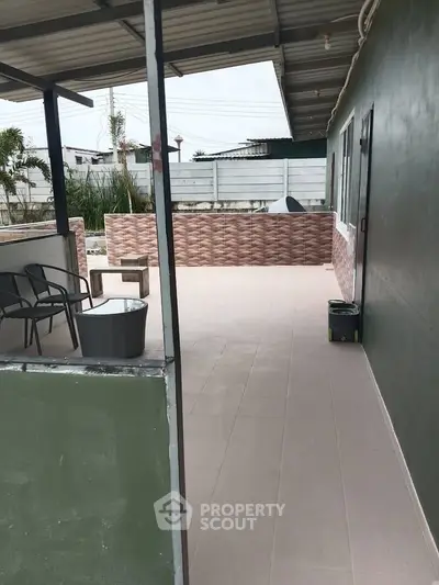 Spacious outdoor patio with seating area and modern design, perfect for relaxation and entertainment.