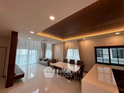 Spacious modern living room with elegant dining area and large windows
