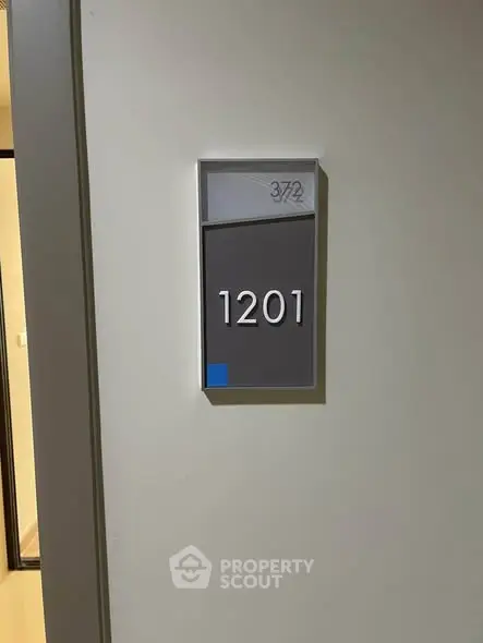 Modern apartment door with unit number 1201 in sleek design.