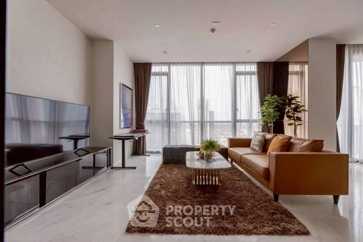 Luxurious modern living room with large windows and city view, featuring elegant furniture and decor.