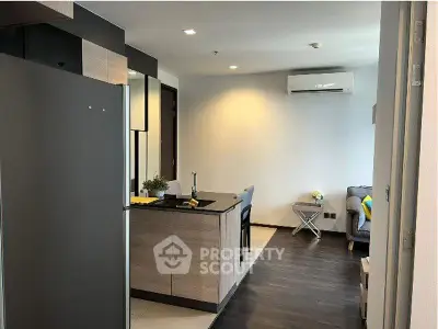 Modern open-layout kitchen with sleek design and cozy living area, perfect for urban living.