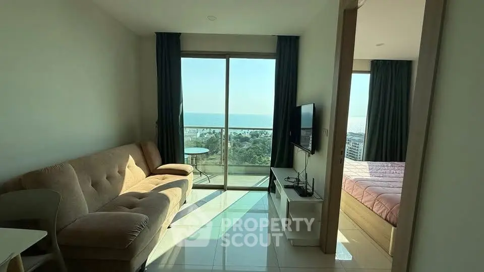 Modern living room with ocean view and balcony access in a stylish apartment