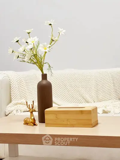Stylish living room with elegant decor, featuring a cozy sofa and chic wooden coffee table.