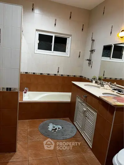 Charming bathroom with bathtub and stylish tile design, perfect for relaxation.