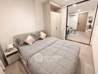 Modern bedroom with cozy bedding and stylish decor in a contemporary apartment.
