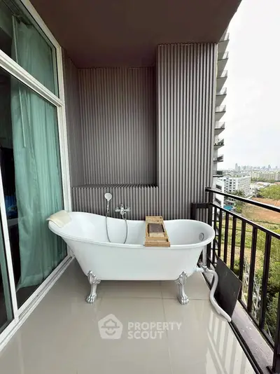 Unique balcony with bathtub offering city views and relaxation space.