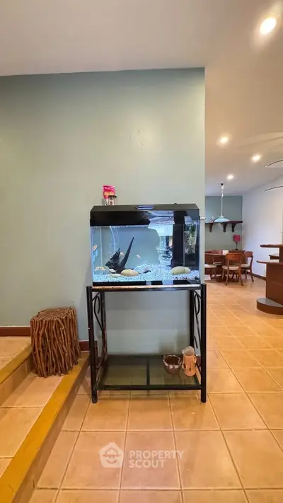 Charming interior with fish tank and dining area, perfect for cozy living.