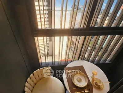 Chic urban balcony with elegant dining setup and city view