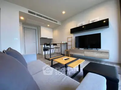 Modern living room with sleek furniture and wall-mounted TV in a stylish apartment.