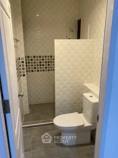 Modern bathroom with sleek tile design and efficient layout.