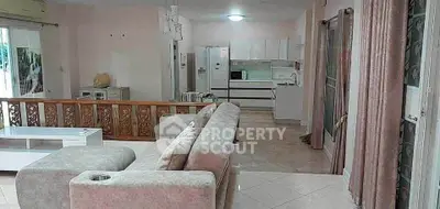 Spacious open-plan living room with modern kitchen and cozy seating area.