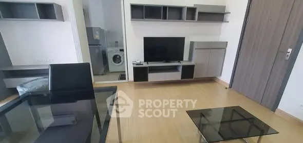 Modern living room with sleek furniture and in-unit washing machine