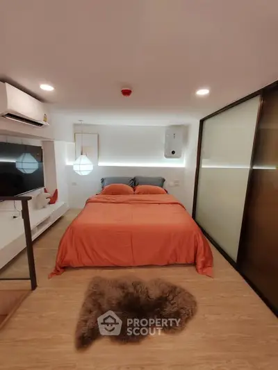 Modern bedroom with cozy orange bedding and stylish decor