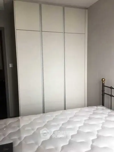 Cozy bedroom with modern wardrobe and comfortable bed