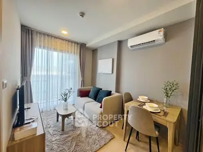 Modern living room with cozy furniture and natural light, perfect for relaxation and entertainment.