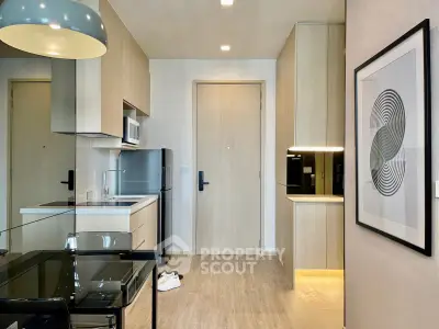 Modern kitchen with sleek cabinetry and integrated appliances in a stylish apartment.