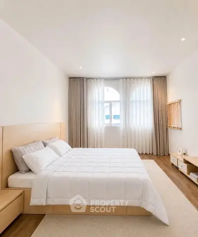 Spacious modern bedroom with elegant decor and natural light