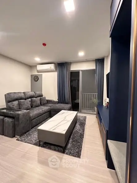 Modern living room with plush gray sofa and sleek marble coffee table