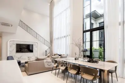 Luxurious modern living room with high ceilings and elegant decor in a prestigious property.
