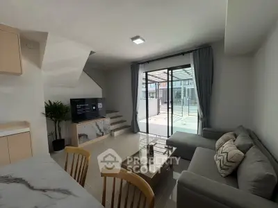 Modern living room with sleek design, large windows, and stylish furniture in a contemporary home.