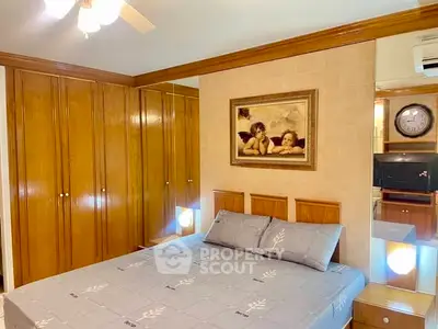 Cozy bedroom with wooden wardrobe and elegant decor, featuring a comfortable bed and classic artwork.