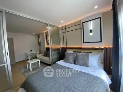 Modern bedroom with sliding glass doors and cozy living area