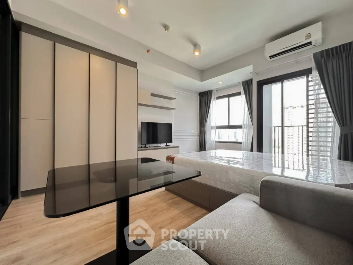 Modern studio apartment with sleek design and natural light in urban setting.