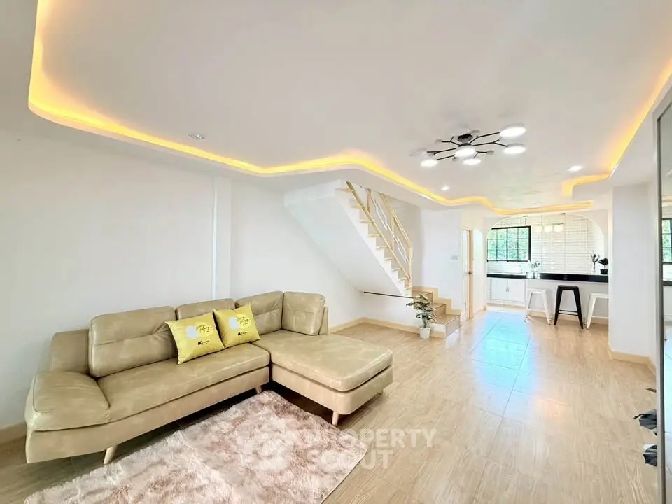 Modern living room with stylish lighting and open kitchen layout