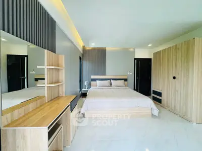 Spacious modern bedroom with sleek wooden furniture and elegant lighting