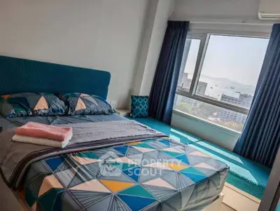 Modern bedroom with stunning ocean view and stylish geometric bedding