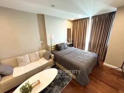 Modern bedroom with cozy sofa and elegant decor